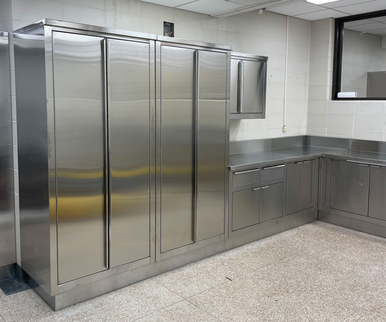 Stainless steel storage cabinets and countertop in a kitchen